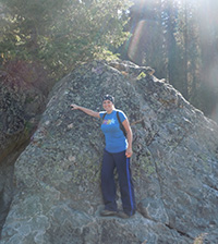 Summer Kervin next to a boulder