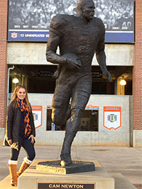 Debbie Penso next to an Auburn statue