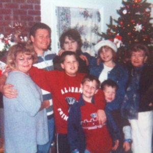 Brandon as a child with his family wearing Alabama gear