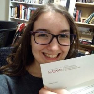 Noella holding her letter of acceptance from UA