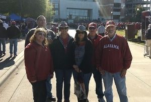 Rachel and her family in Alabama clothing outside of Bryant-Denny Stadium