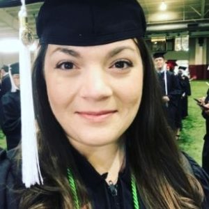 Elizabeth in a graduation cap