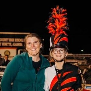 Kimberly with her daughter in her marching band uniform
